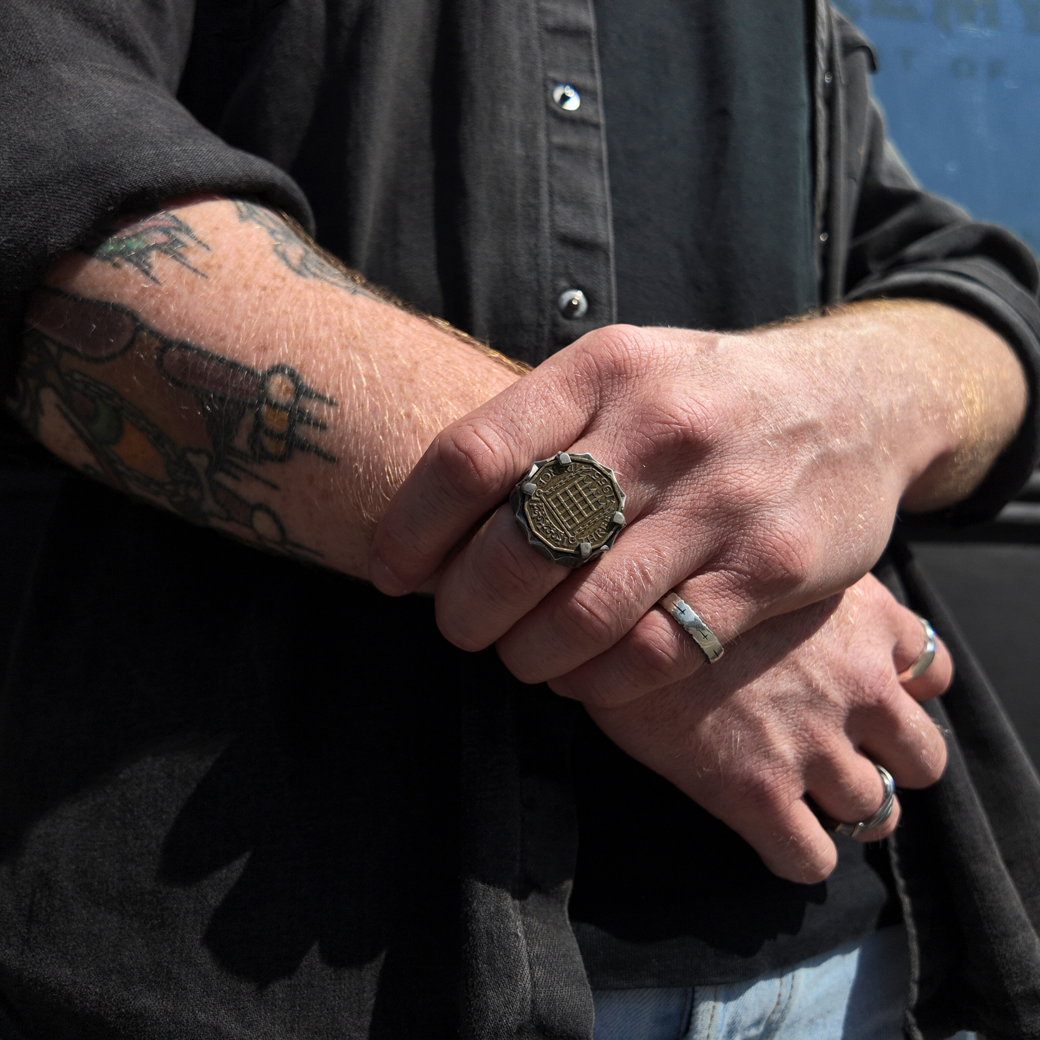 3penny signet ring handshot with man holding wrist