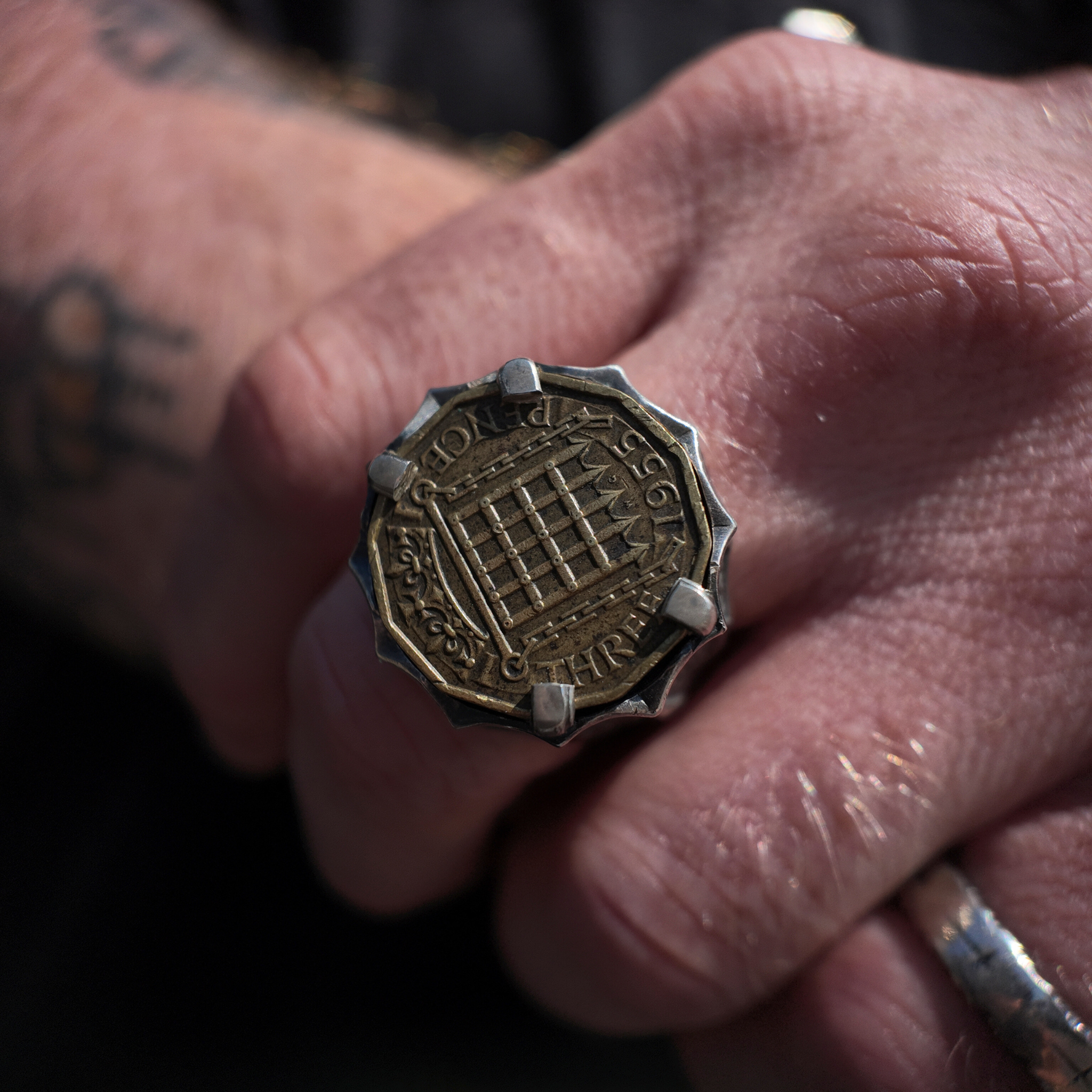 3penny silver signet ring macro shot on hand