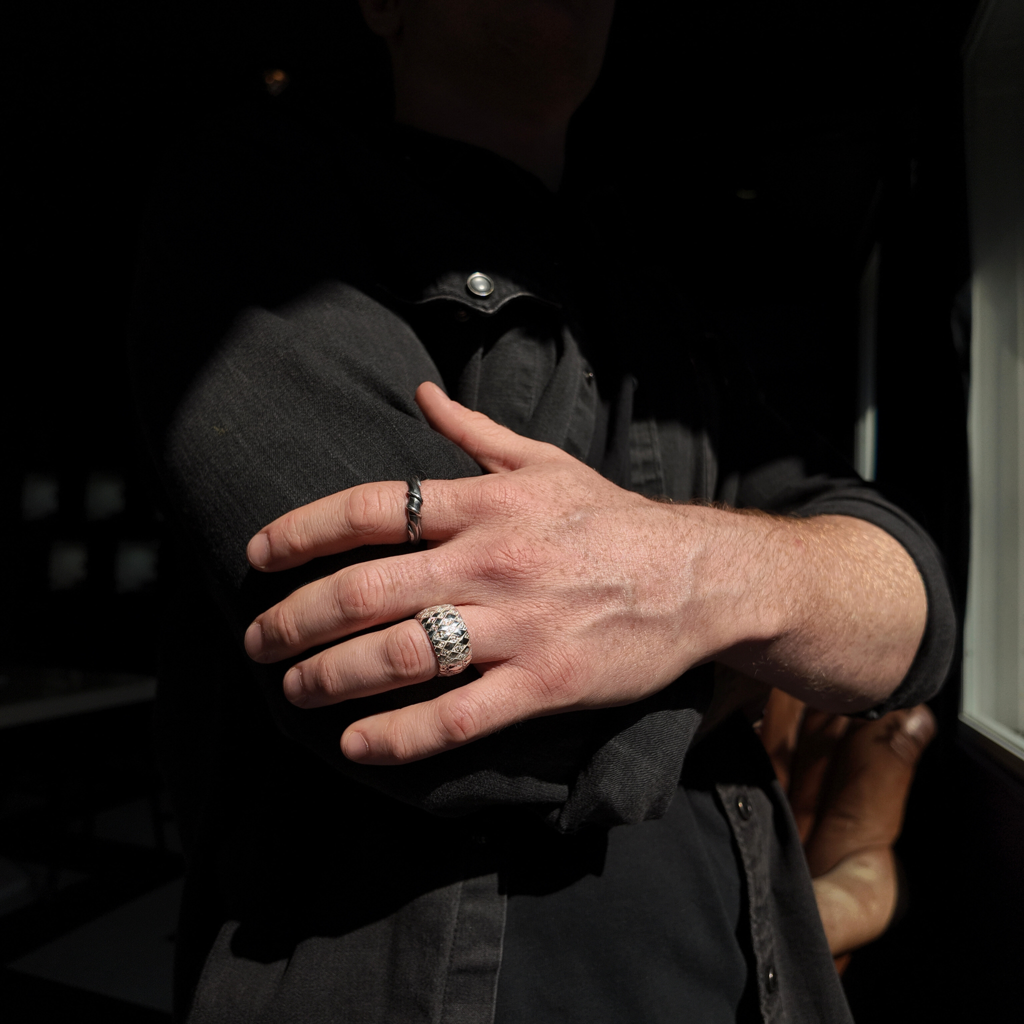 Chequered Silver Curved Ring with polished finish on hand