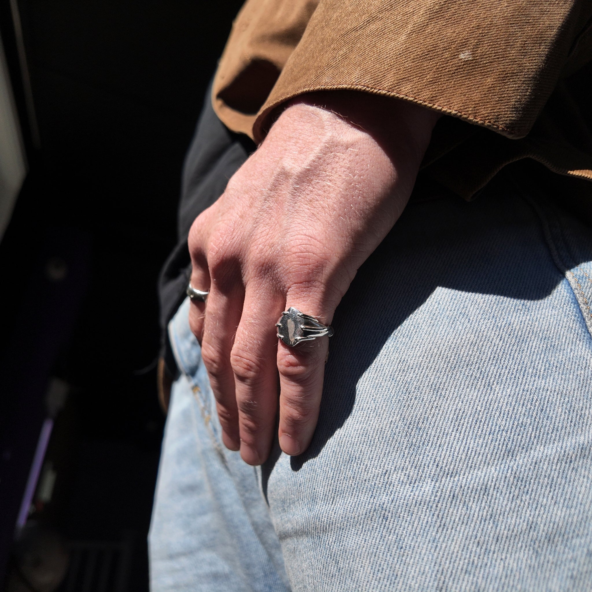 Entwine small signet ring on mans hand