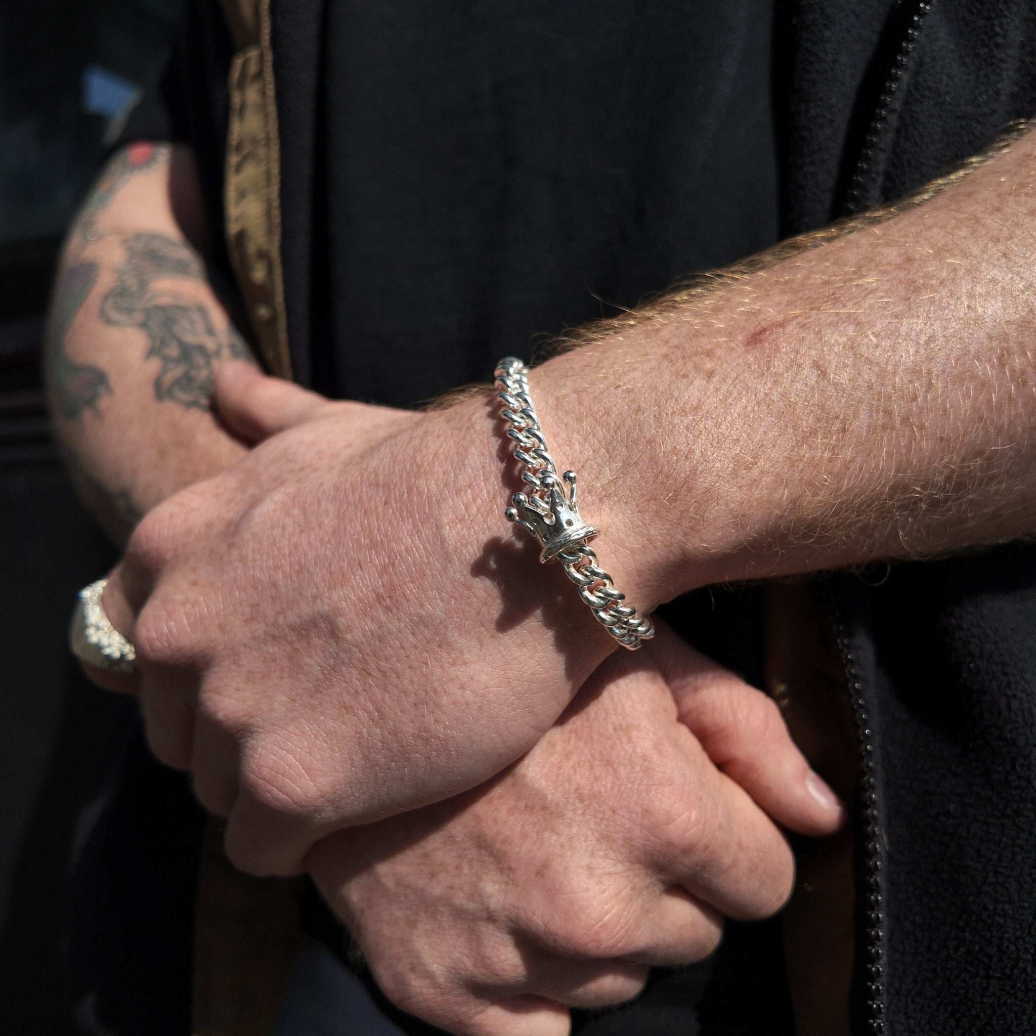 King & Queen Silver Crown Bracelet on a polished chain on a mans wrist