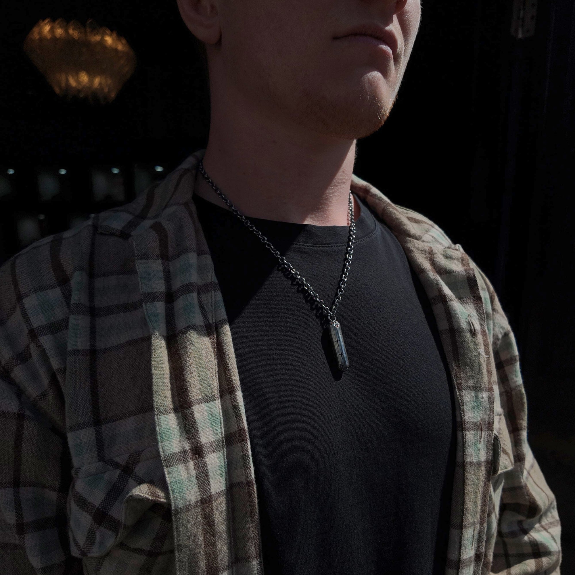 Large silver cylinder necklace from Trinity collection around neck