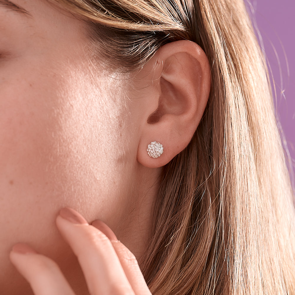 These Cone Lunas come in a silver finish. These textured studs measure 7mm wide and 8mm in length.