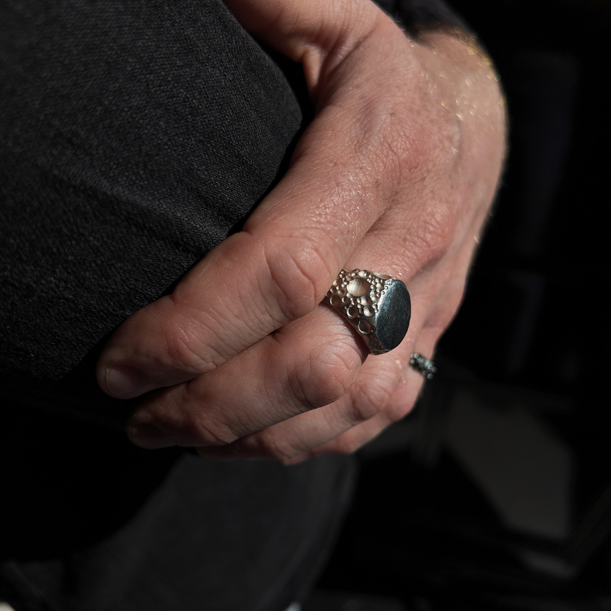 Moon Large silver signet ring on hand - macro lens shot