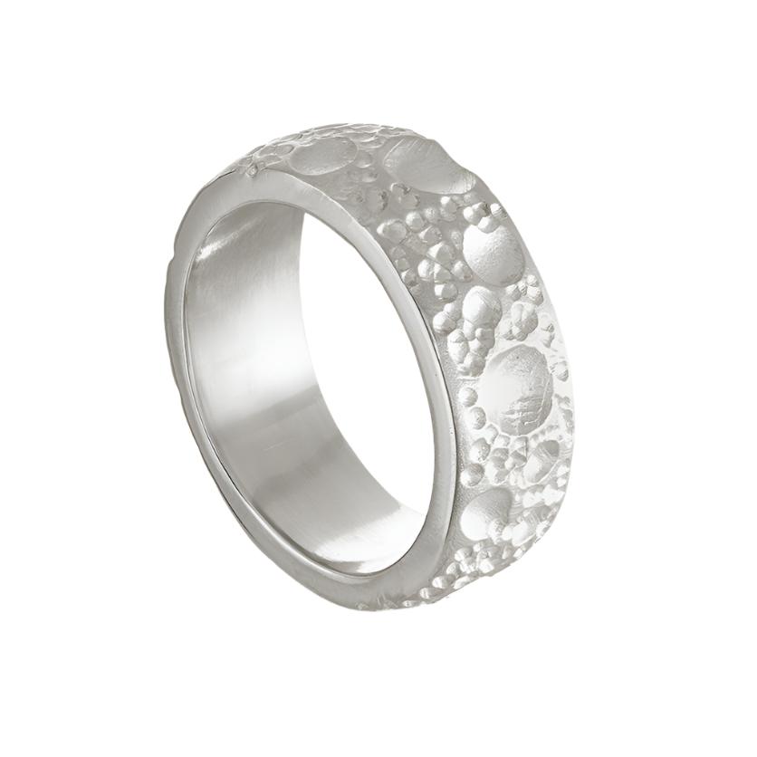 This handmade silver ring measures 8mm in width and is finished with unique textured surface detail and a smooth, polished inside and edges.