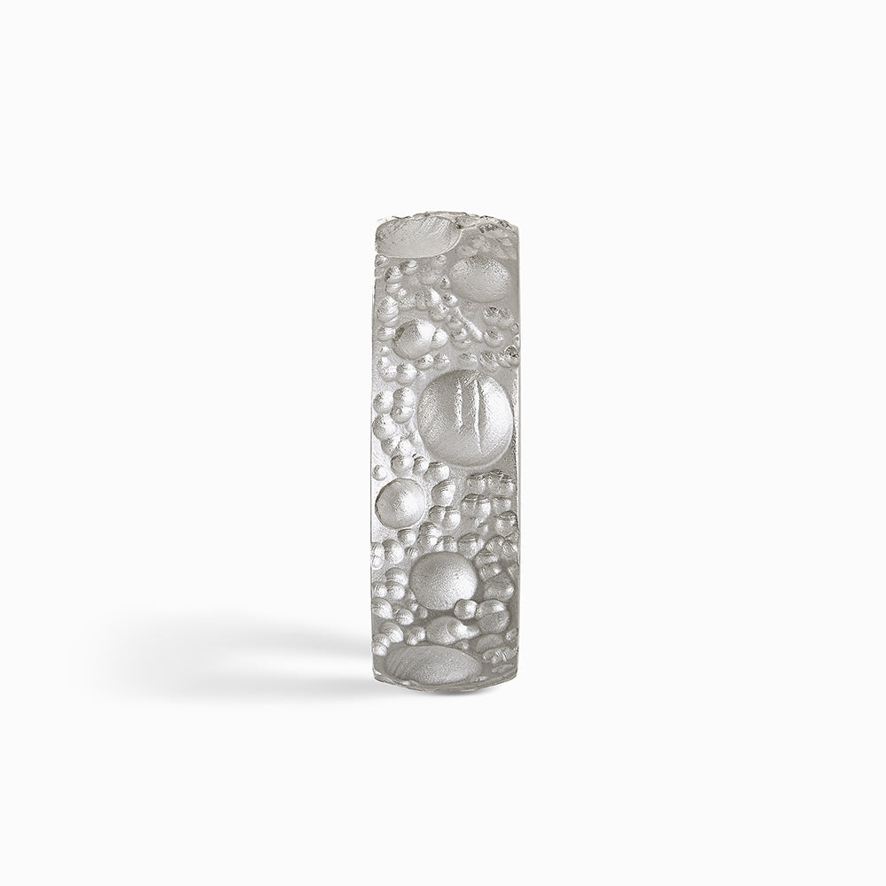 This handmade silver ring measures 8mm in width and is finished with unique textured surface detail and a smooth, polished inside and edges.
