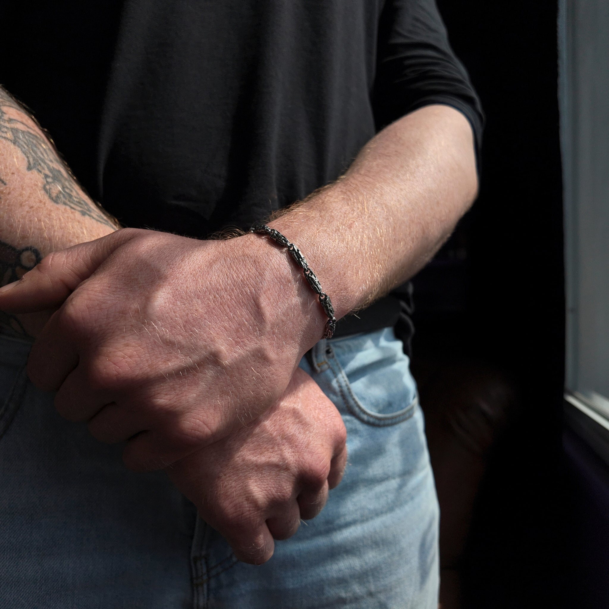 small Luna silver bracelet with oxidised finish and hands crossed