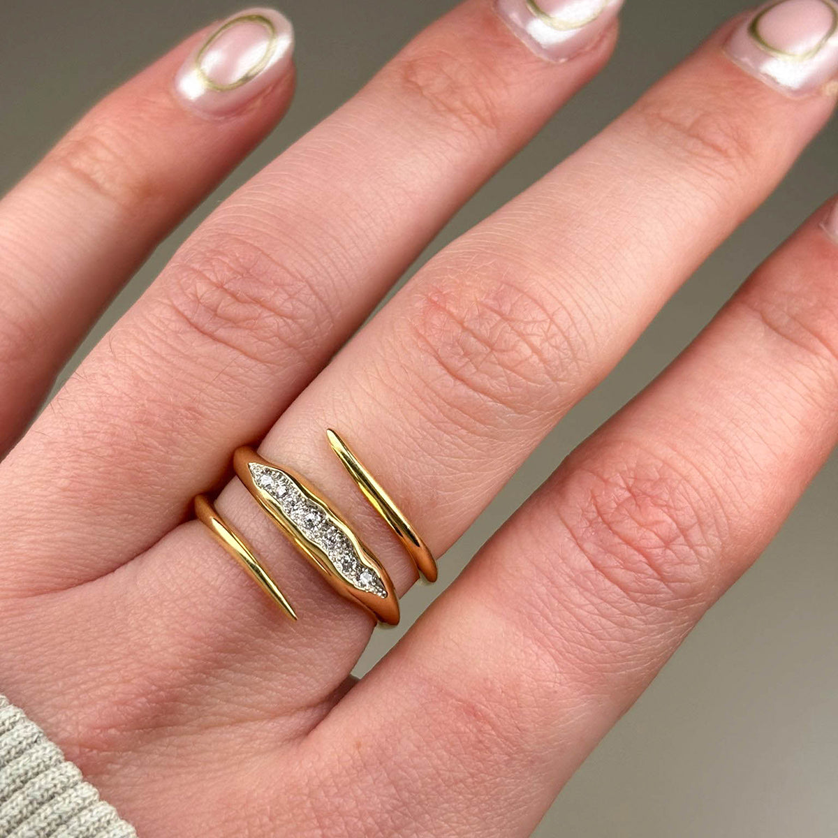 The band measures 3mm and is pavé set with seven white diamonds which total .20pts of a carat.