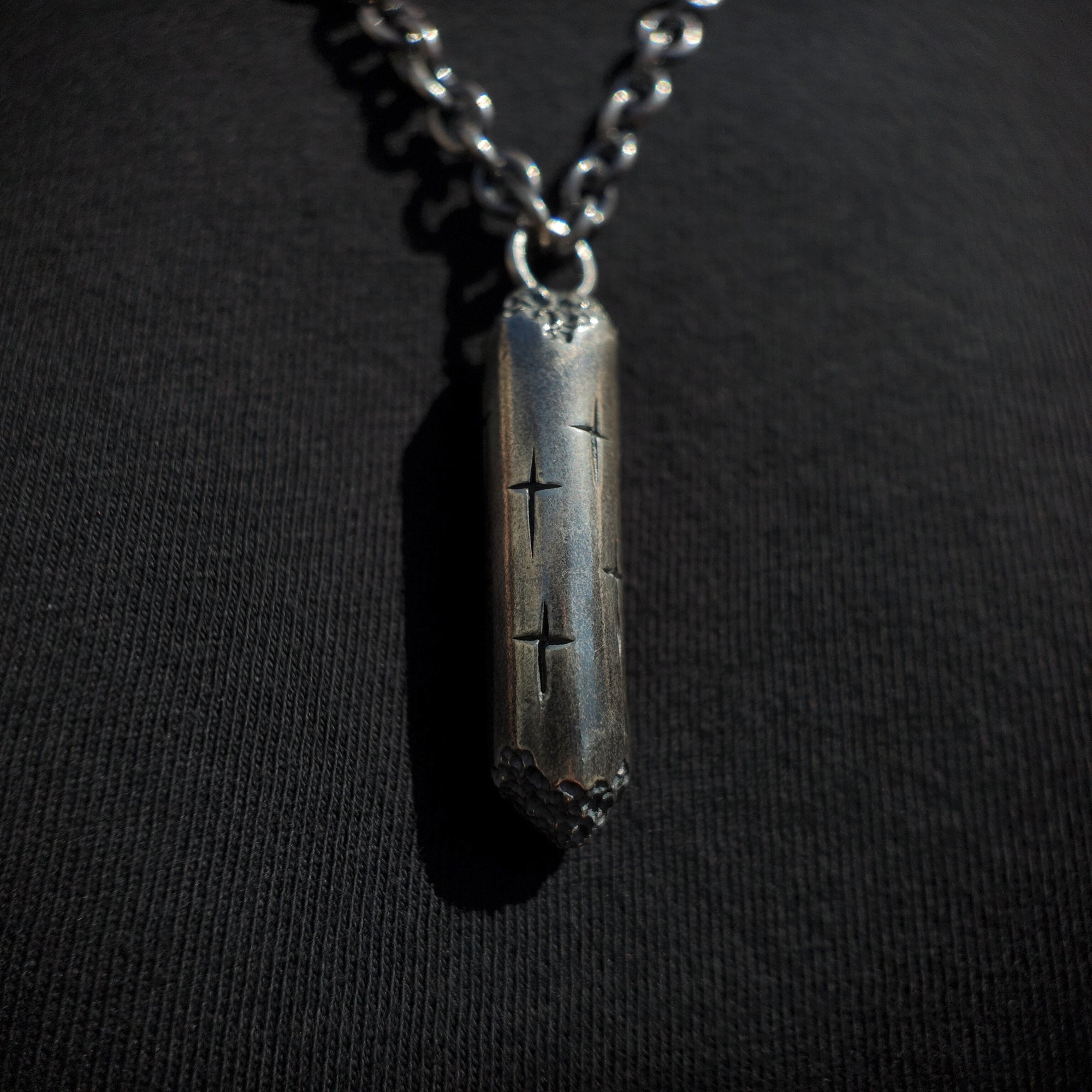 macro shot of large silver cylinder necklace from Trinity collection