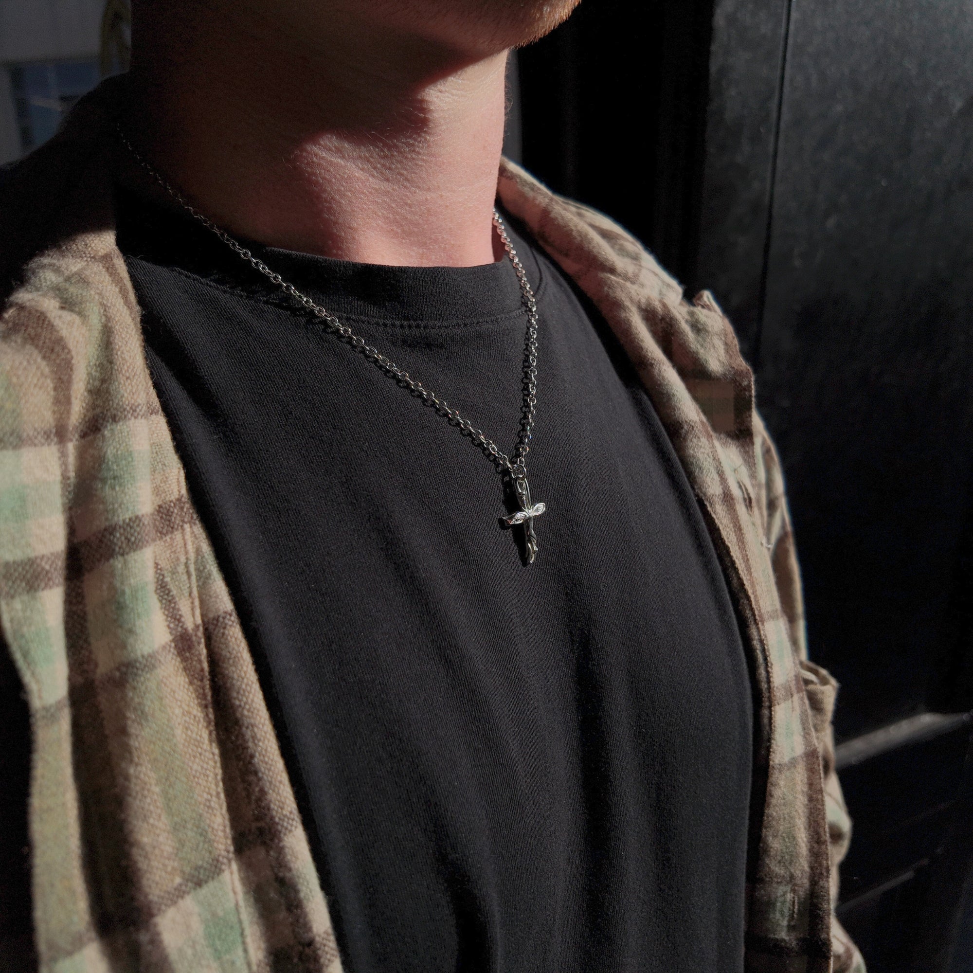 libertine small polished cross necklace worn on neck
