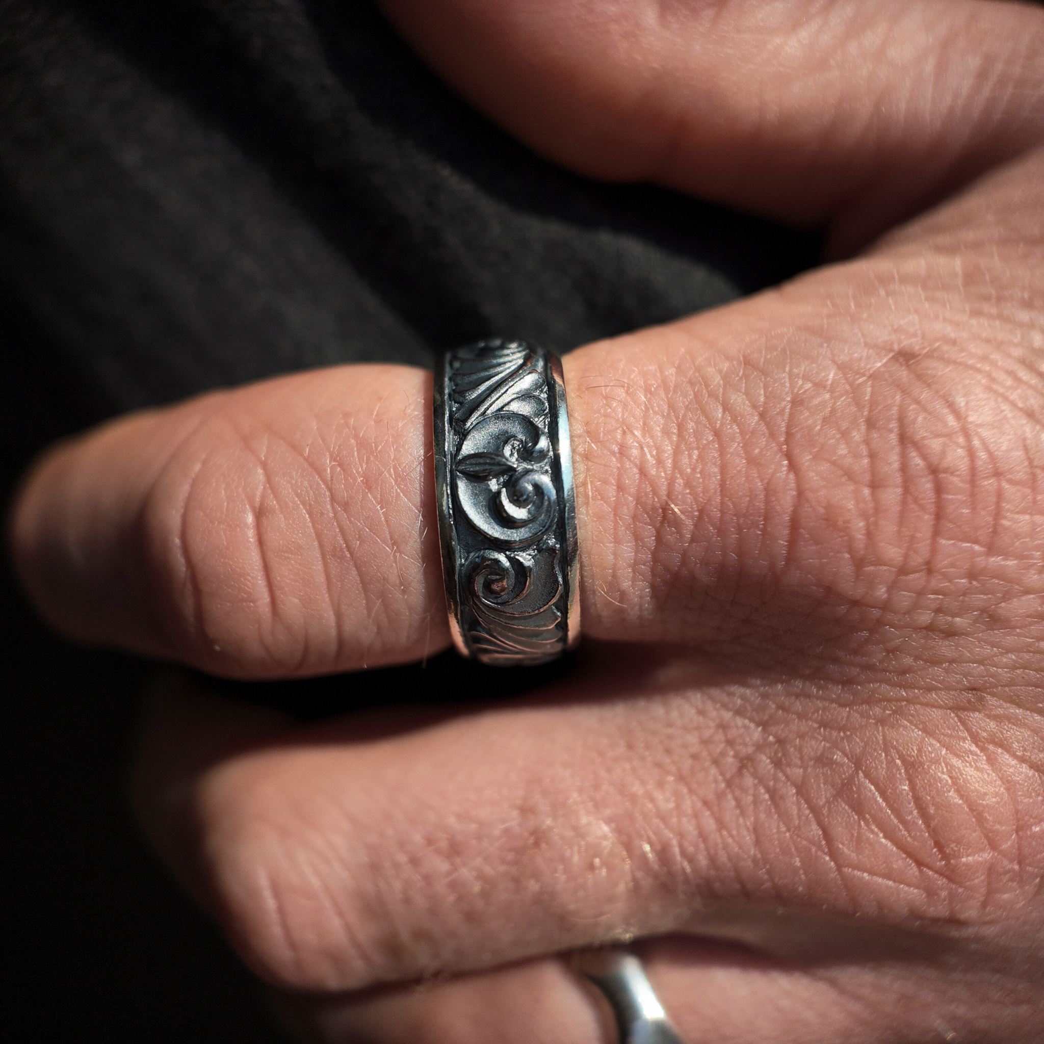 silver gun engraved ring macro handshot