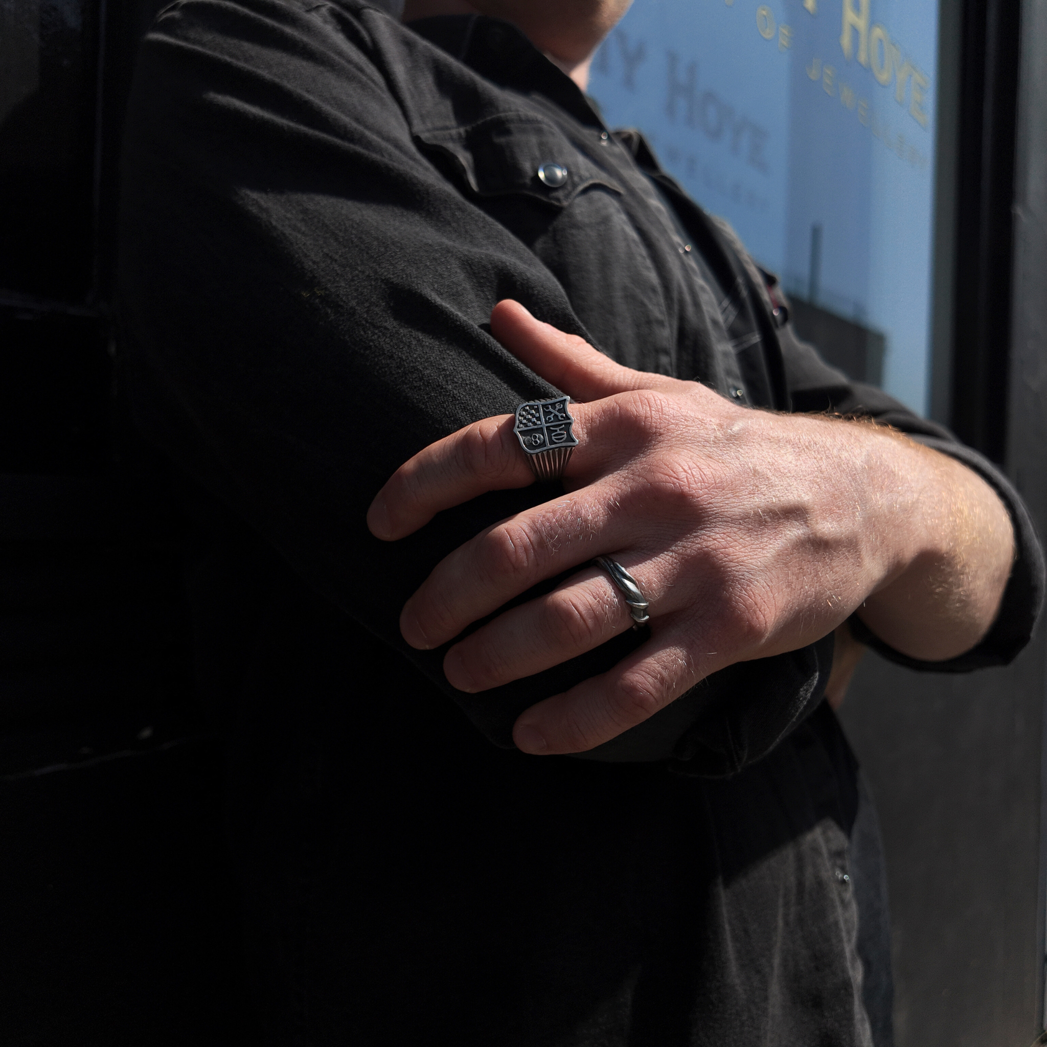 Hoye Division shield signet ring on hand with hand holding opposite arm