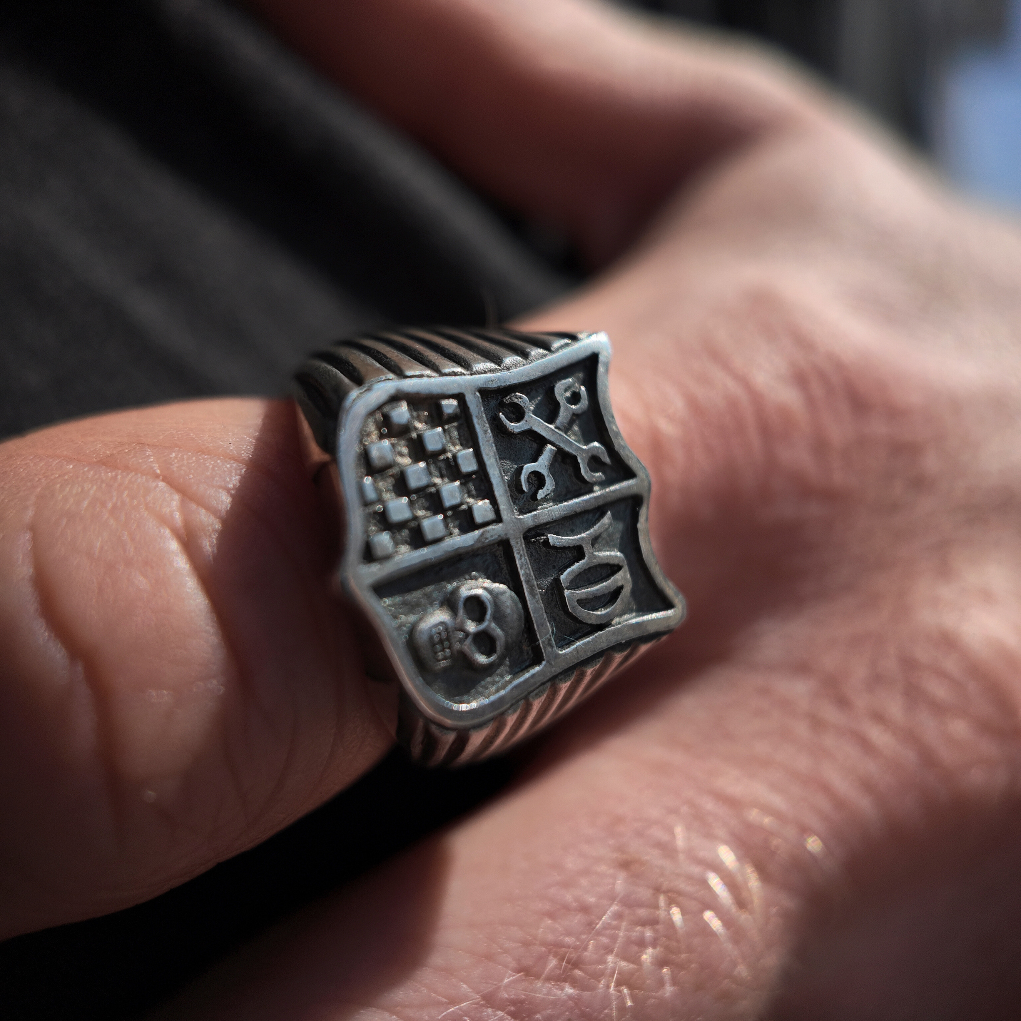 Hoye Division shield signet ring macro shot on hand