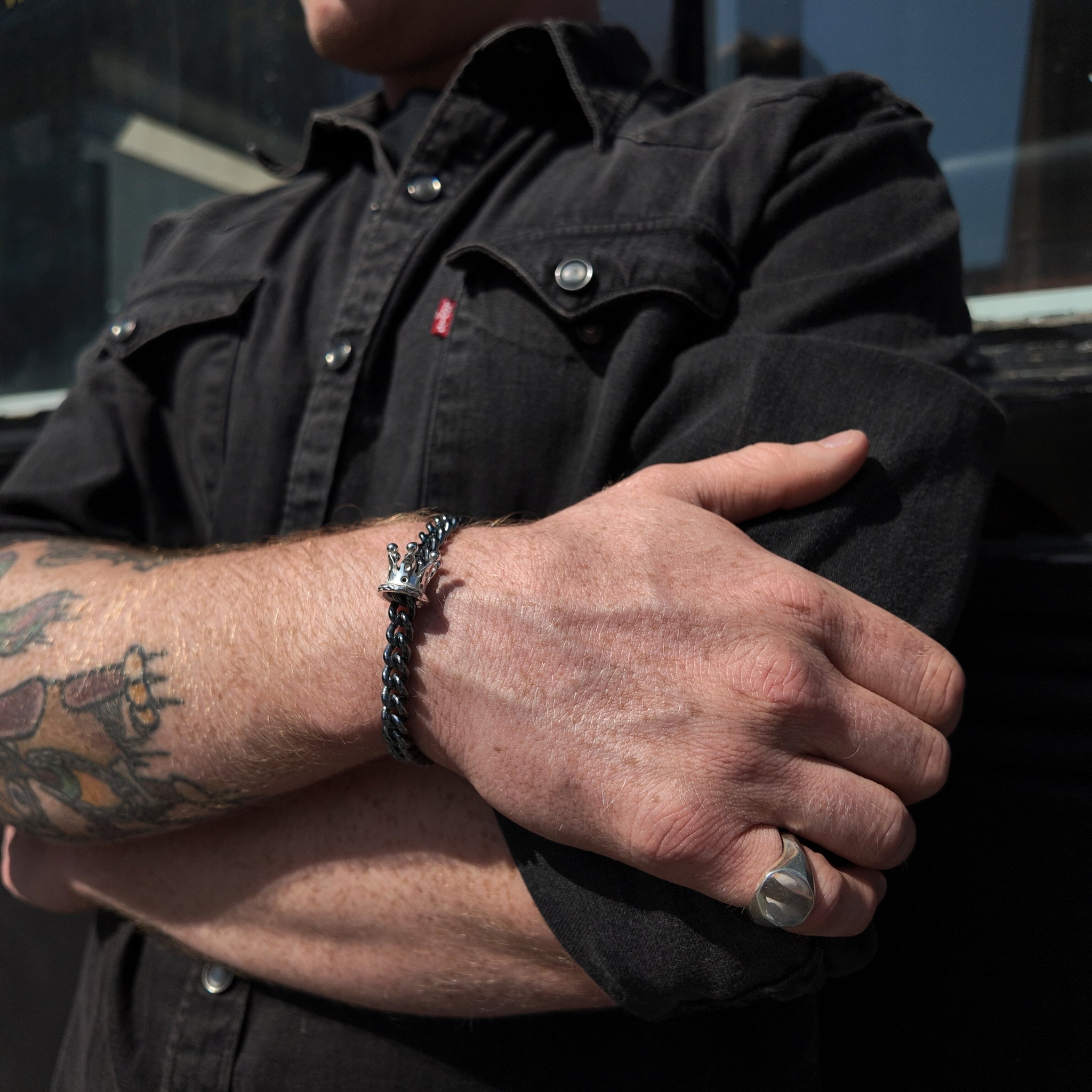 King & Queen Silver Crown Bracelet with oxidised chain on a mans wrist