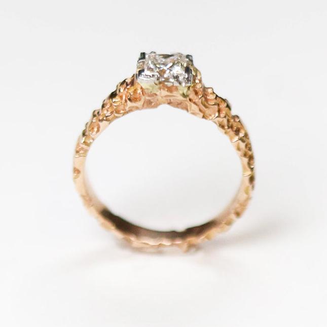 This unique solitaire is hand carved in 18ct rose gold, and set in platinum with a beautiful .56pt princess cut diamond.