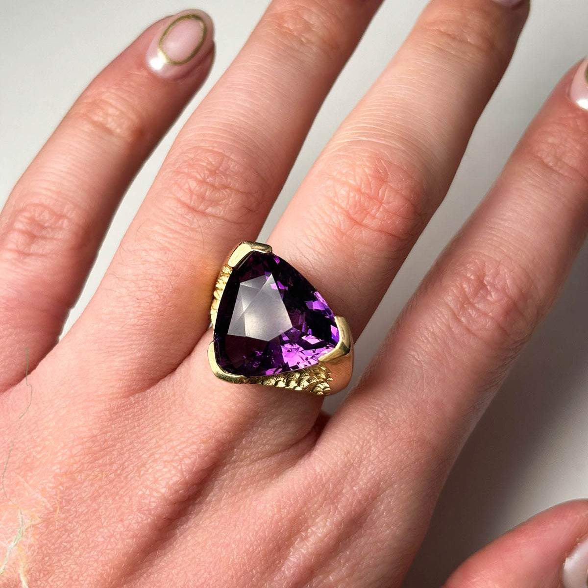 This unique solitaire is hand carved in 9ct yellow gold set with a beautiful 18 carat amethyst stone.