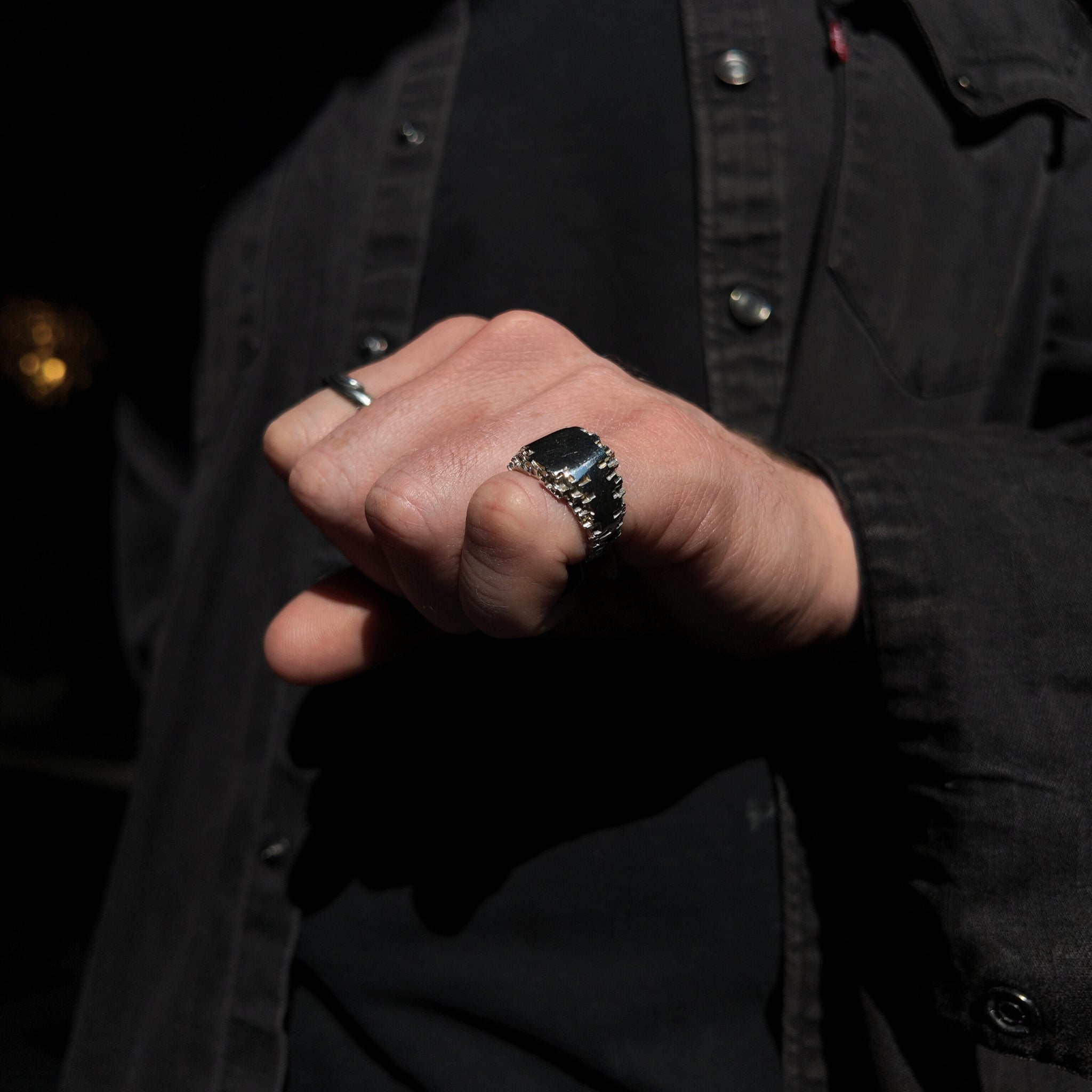 Luna small signet ring with a polished finish on a mans pinky finger