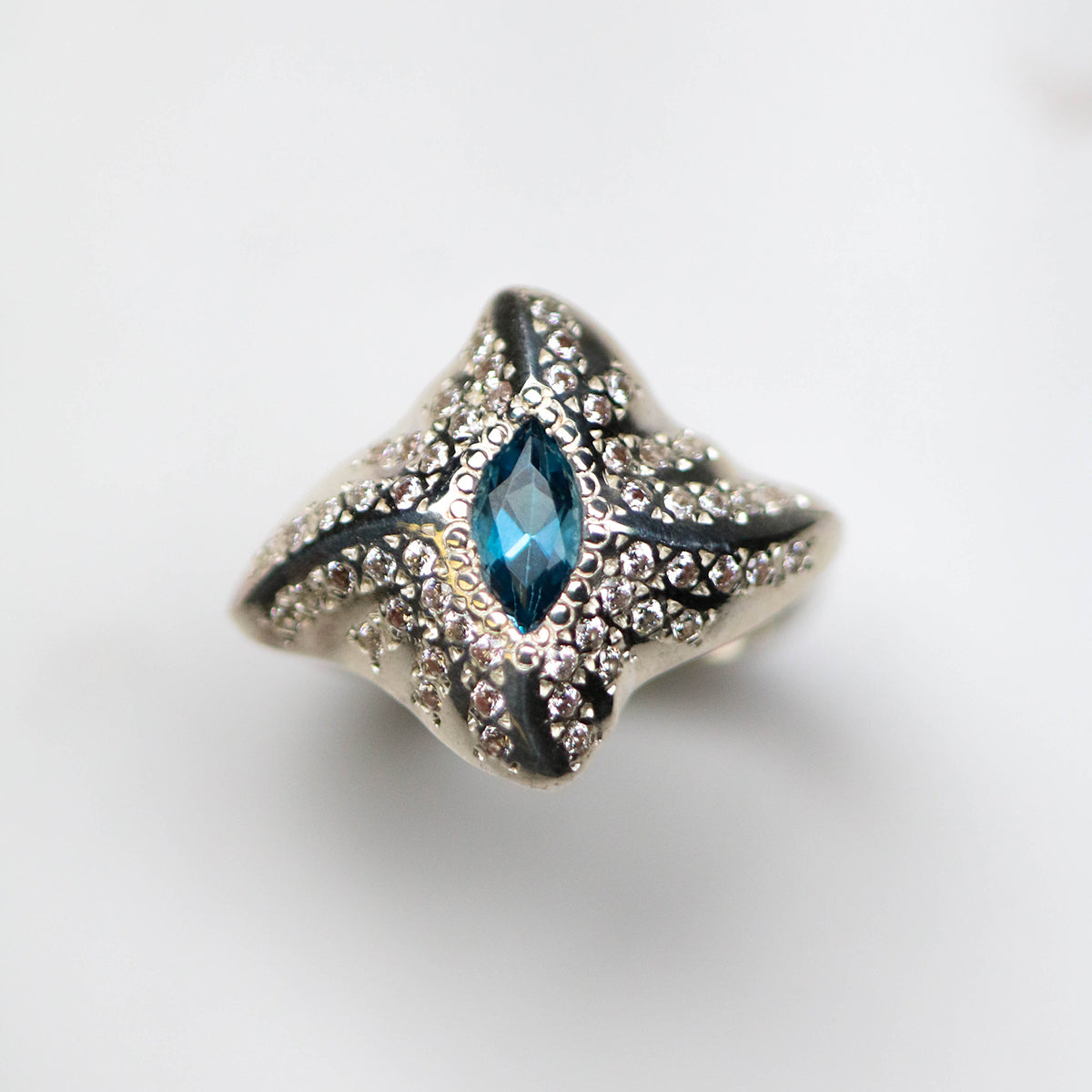 The ring features a central marquise gemstone and 13 pavé set white cubic zirconia on each wing plate to maximise sparkle from every angle.