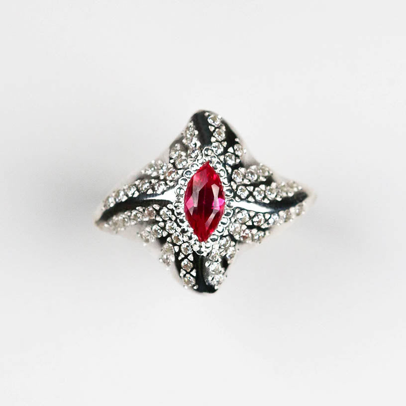 The ring features a central marquise gemstone and 13 pavé set white cubic zirconia on each wing plate to maximise sparkle from every angle.