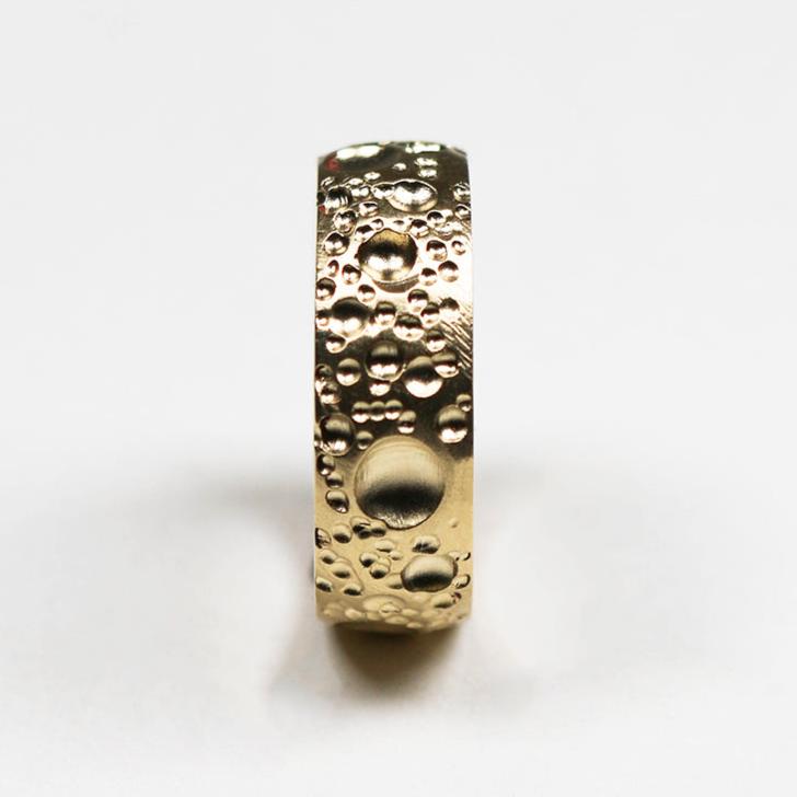 This handmade 9ct yellow gold band measures 6mm in width and is finished with unique textured surface detail and a smooth, polished inside for comfort.