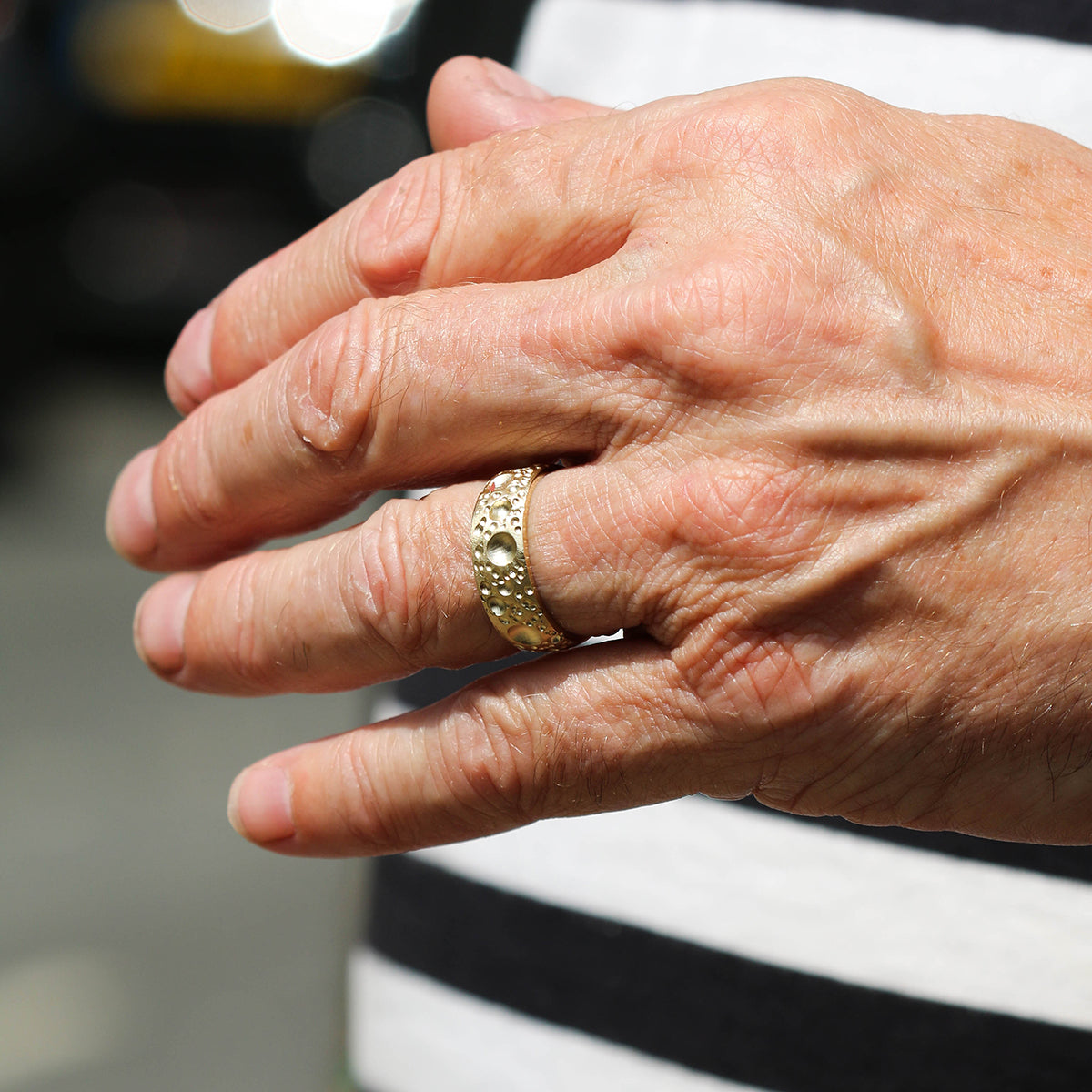 This handmade 9ct yellow gold band measures 6mm in width and is finished with unique textured surface detail and a smooth, polished inside for comfort.