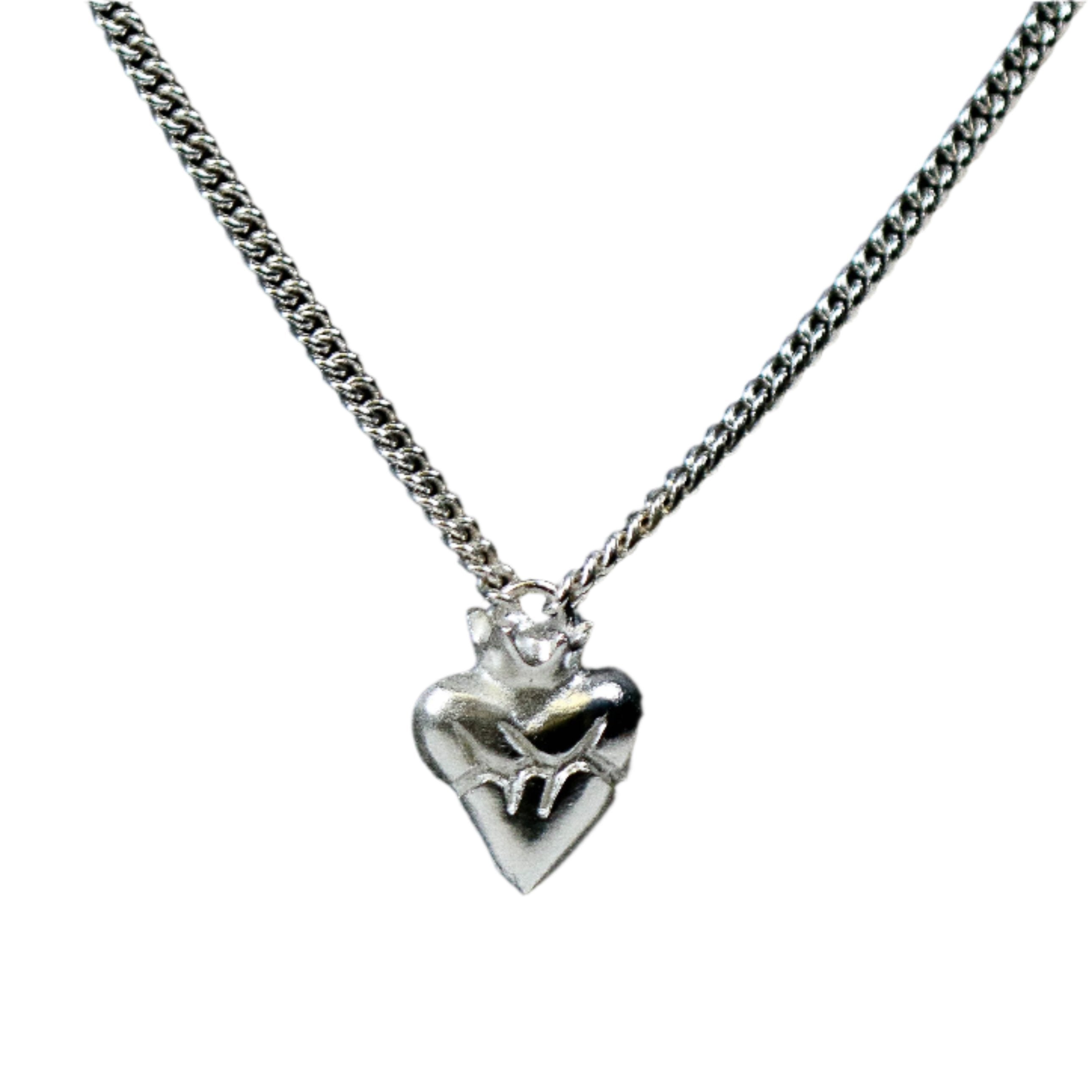 Sacred heart silver necklace on white background