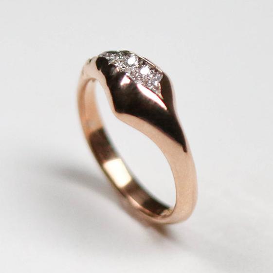 Designed so it sits off-centre for an asymmetric look, the band tapers from 7.5mm to 2.75mm in width. Inspired by crystal geodes, this ring is pavé set with twelve tiny, round, brilliant cut white diamonds which total .40pts of a carat.