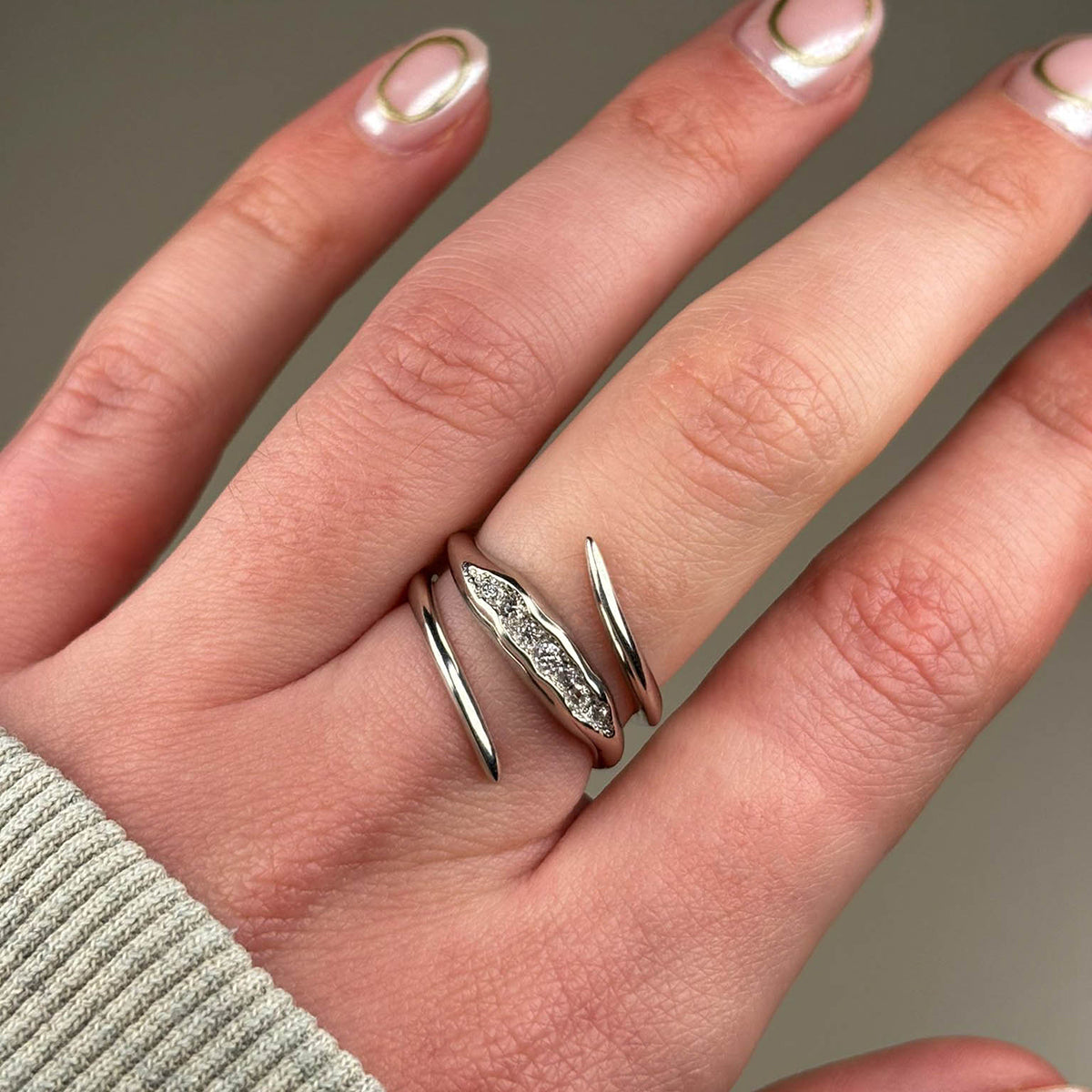 The band measures 3mm and is pavé set with seven white diamonds which total .20pts of a carat. 