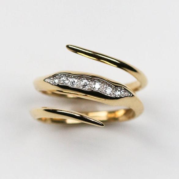 The band measures 3mm and is pavé set with seven white diamonds which total .20pts of a carat. 