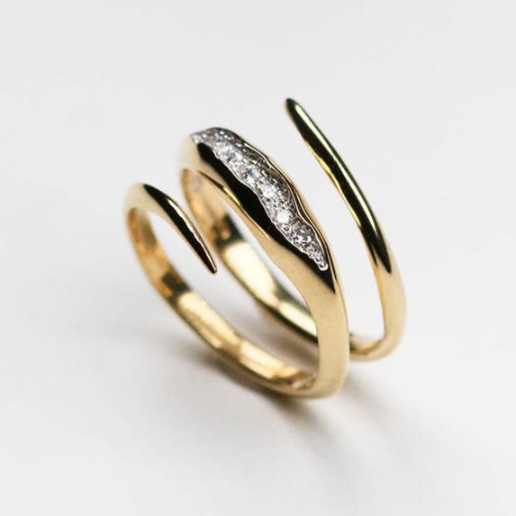 The band measures 3mm and is pavé set with seven white diamonds which total .20pts of a carat. 