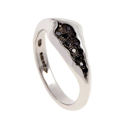 Handmade in platinum, the ring tapers from 7.5mm to 2.75mm in width and is pavé set with 12 black diamonds.