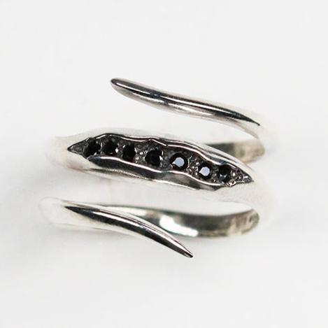 Silver coil ring from Jeremy's Triffid collection, inspired by natural geodes. The band measures 3mm and is set with seven black cubic zirconia.