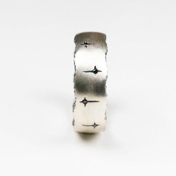 Trinity 18ct white gold band measuring 8mm in width. Set with 10 black diamonds which total .30pts of a carat.