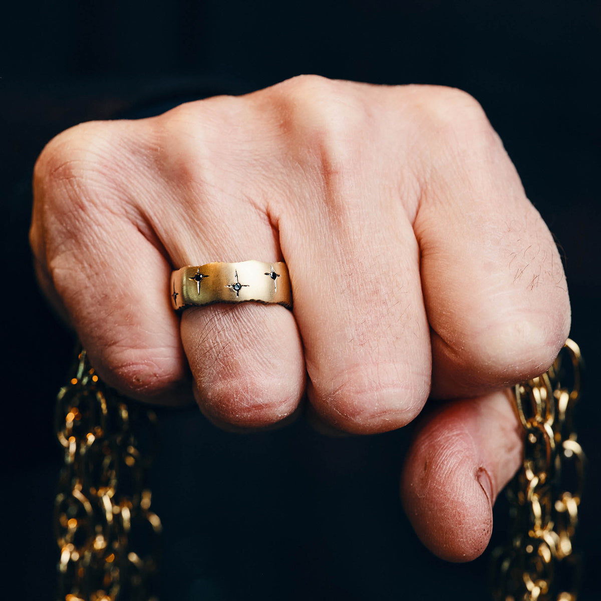 Trinity 9ct yellow gold band measuring 8mm in width with 10 black diamonds.