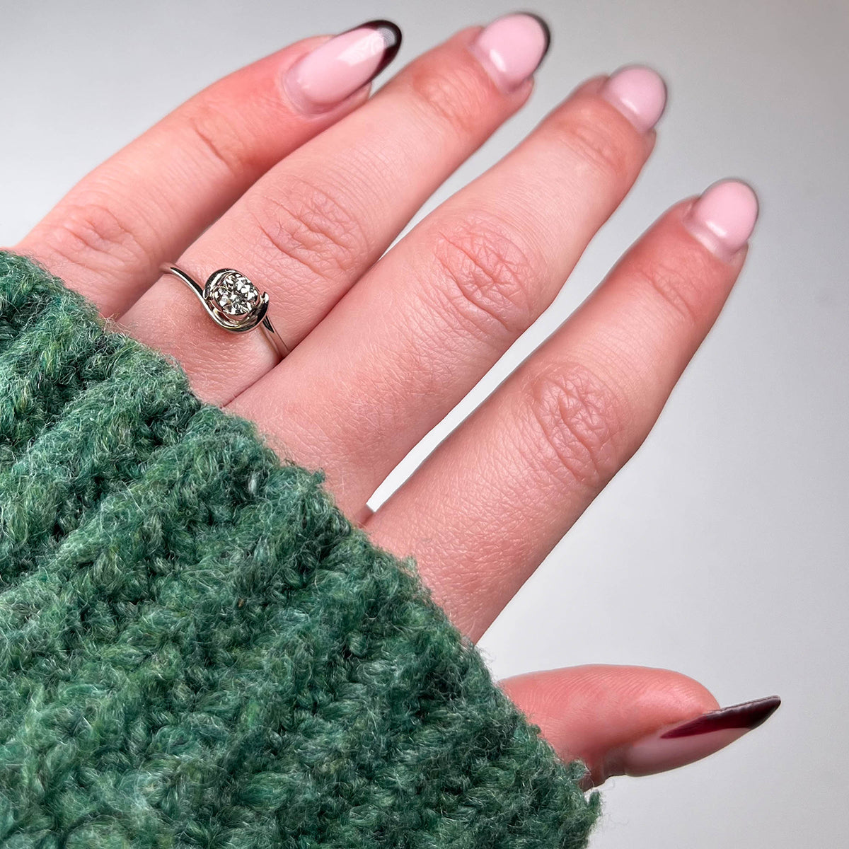 An 18ct white gold simple, fine band with contrasting four petal setting in platinum.