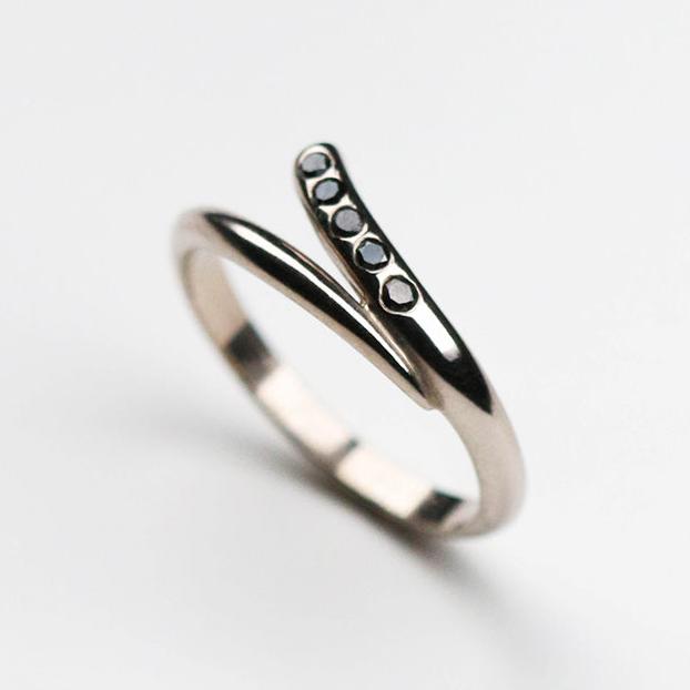 Handmade in 18ct white gold and set with five black diamonds which total .15pts of a carat.