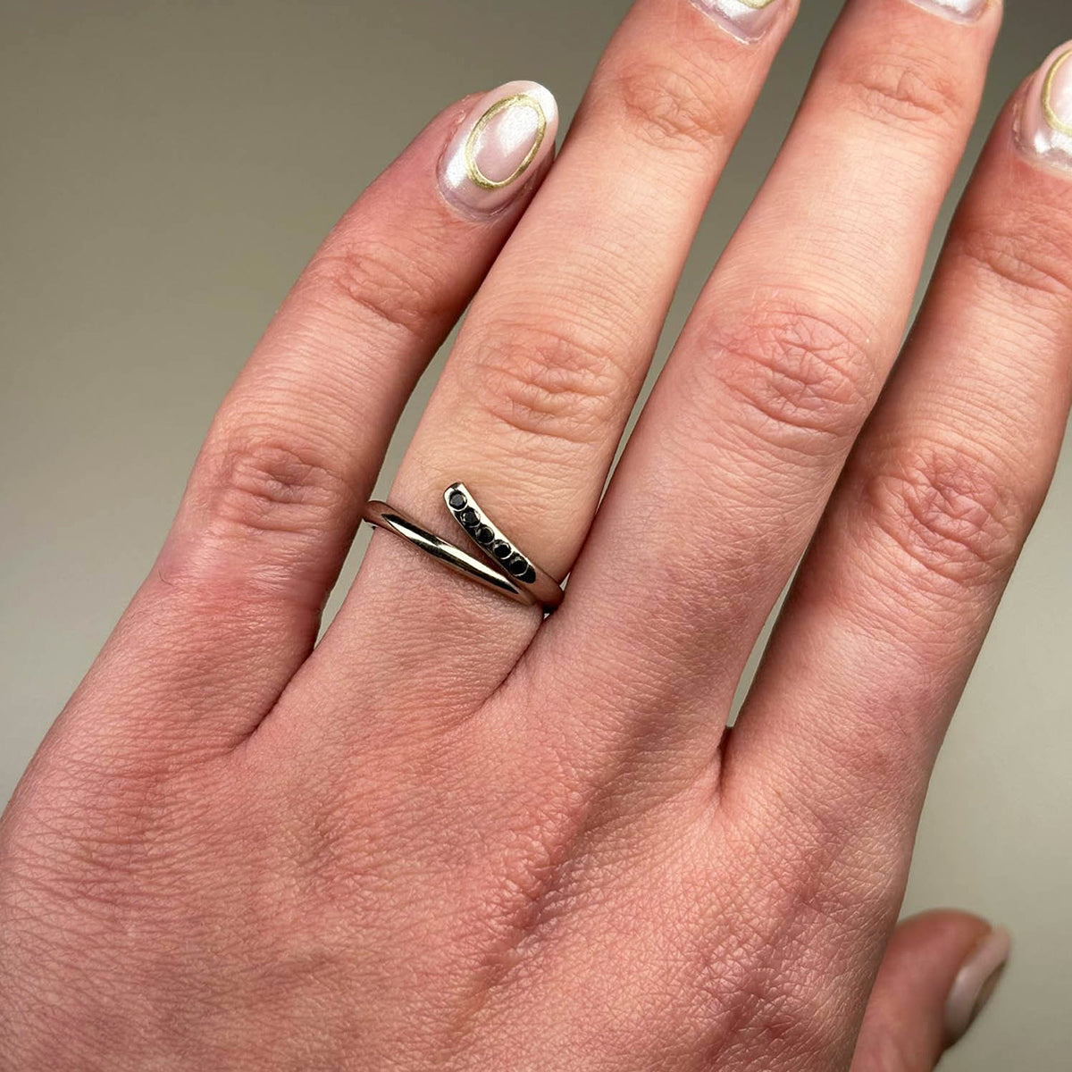 Handmade in 18ct white gold and set with five black diamonds which total .15pts of a carat.