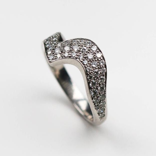 Handmade in Platinum this stunning piece is pavé set with white diamonds. This ring measures 6mm at its widest point and tapers down to 3mm.