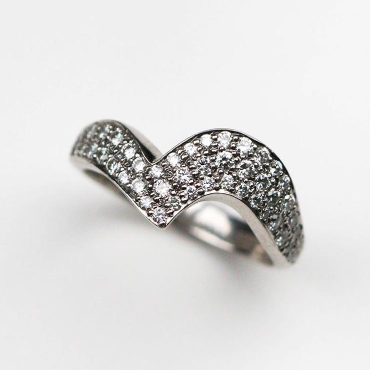 Handmade in Platinum this stunning piece is pavé set with white diamonds. This ring measures 6mm at its widest point and tapers down to 3mm.