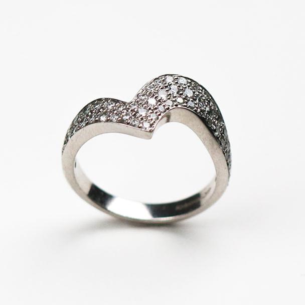 Handmade in Platinum this stunning piece is pavé set with white diamonds. This ring measures 6mm at its widest point and tapers down to 3mm.